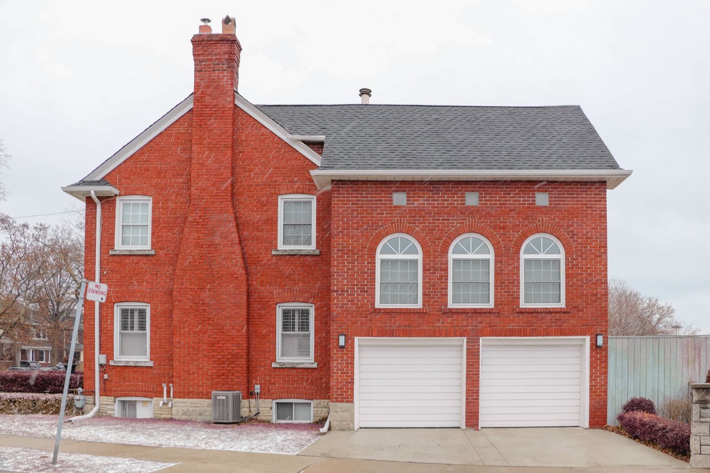 Red brick house with a masonry chimney — the feature home inspectors photograph from the street