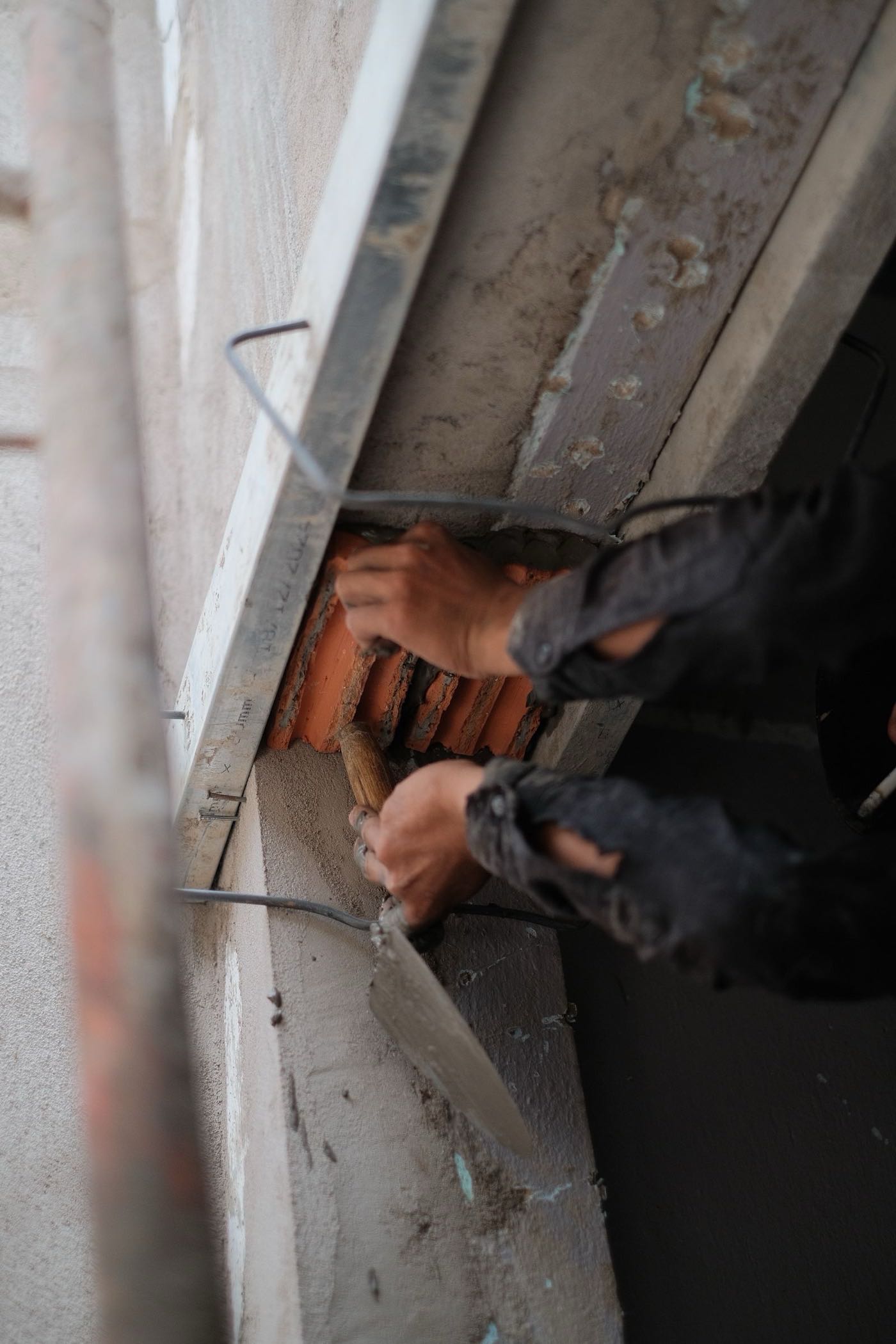 Close-up of a mason's trowel working fresh mortar during a Riverview chimney repair