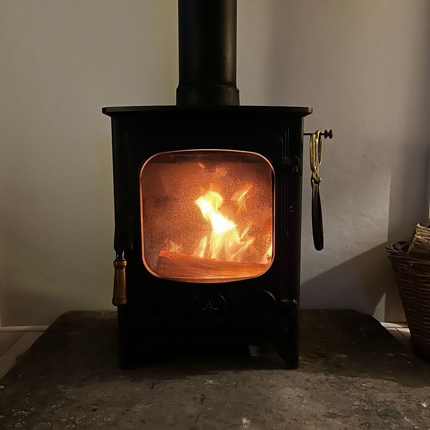 Wood stove burning gently — the appliance a properly sized stainless chimney liner serves